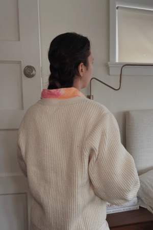 image of back of cardigan and collar of tie dye shirt