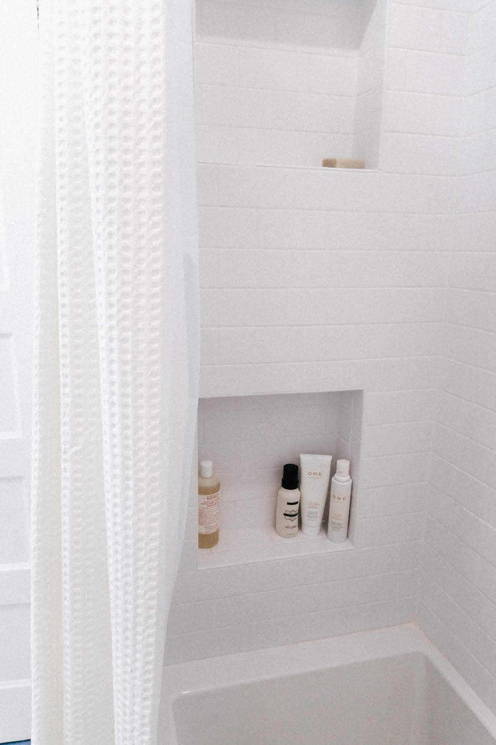 Simply by Simone - Simone Piliero - My Black and White Bathroom Renovation - Finished Photos - Bathtub and Shower Shelves #bathroom #home #renovation #bathroomrenovation #diyhome #bathroomtiles #bathroomdecor #bathroomideas #bathroomrenovationideas