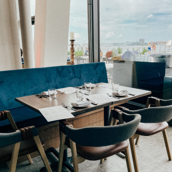 Interior photo of dining table overlooking the water at Woods Hill Pier 4 - Three Day Getaway to Boston Massachusetts Simply by Simone