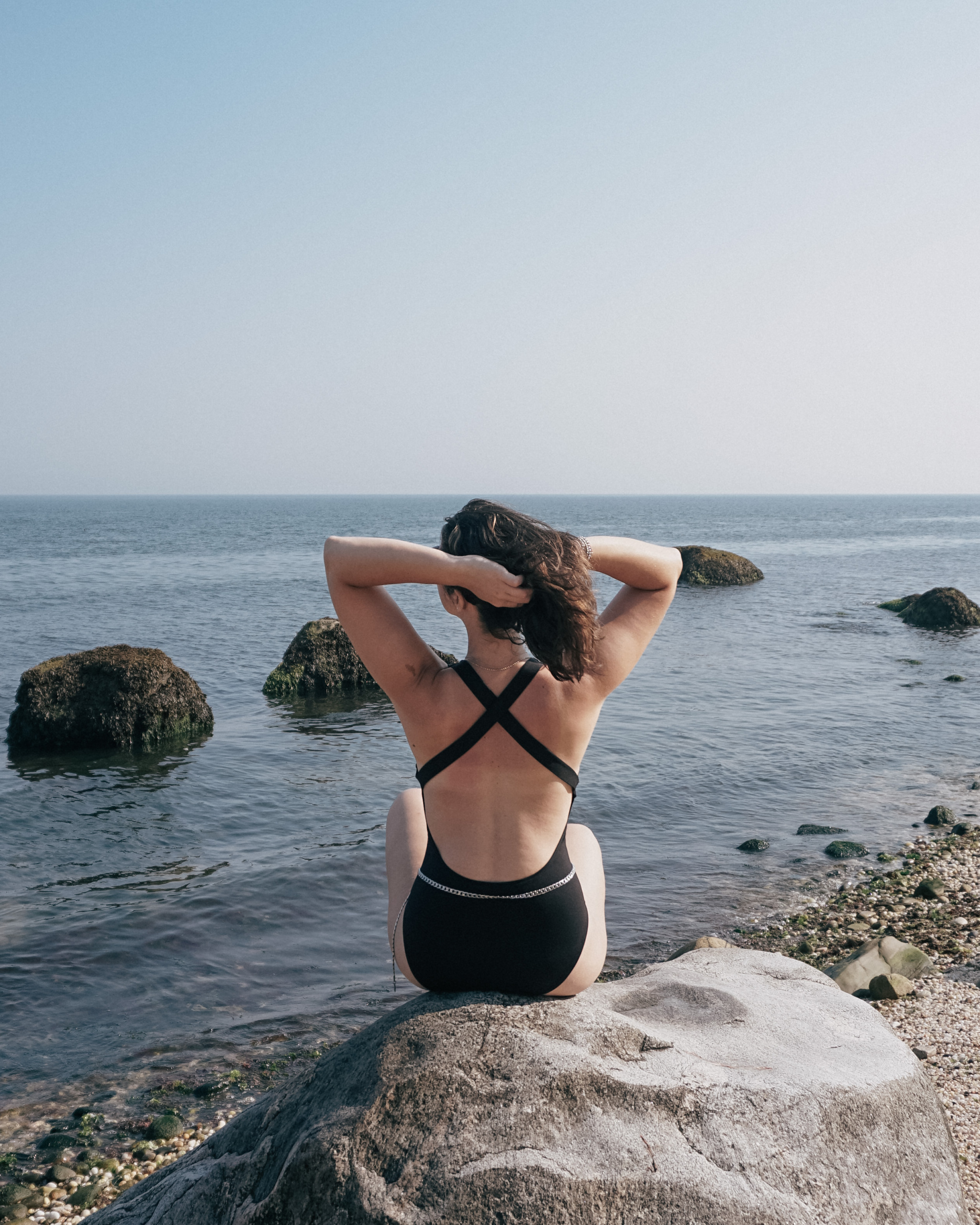 Simply-by-Simone-wearing-black-bathing-suit-at-67-Steps-Beach-greenport-new-york