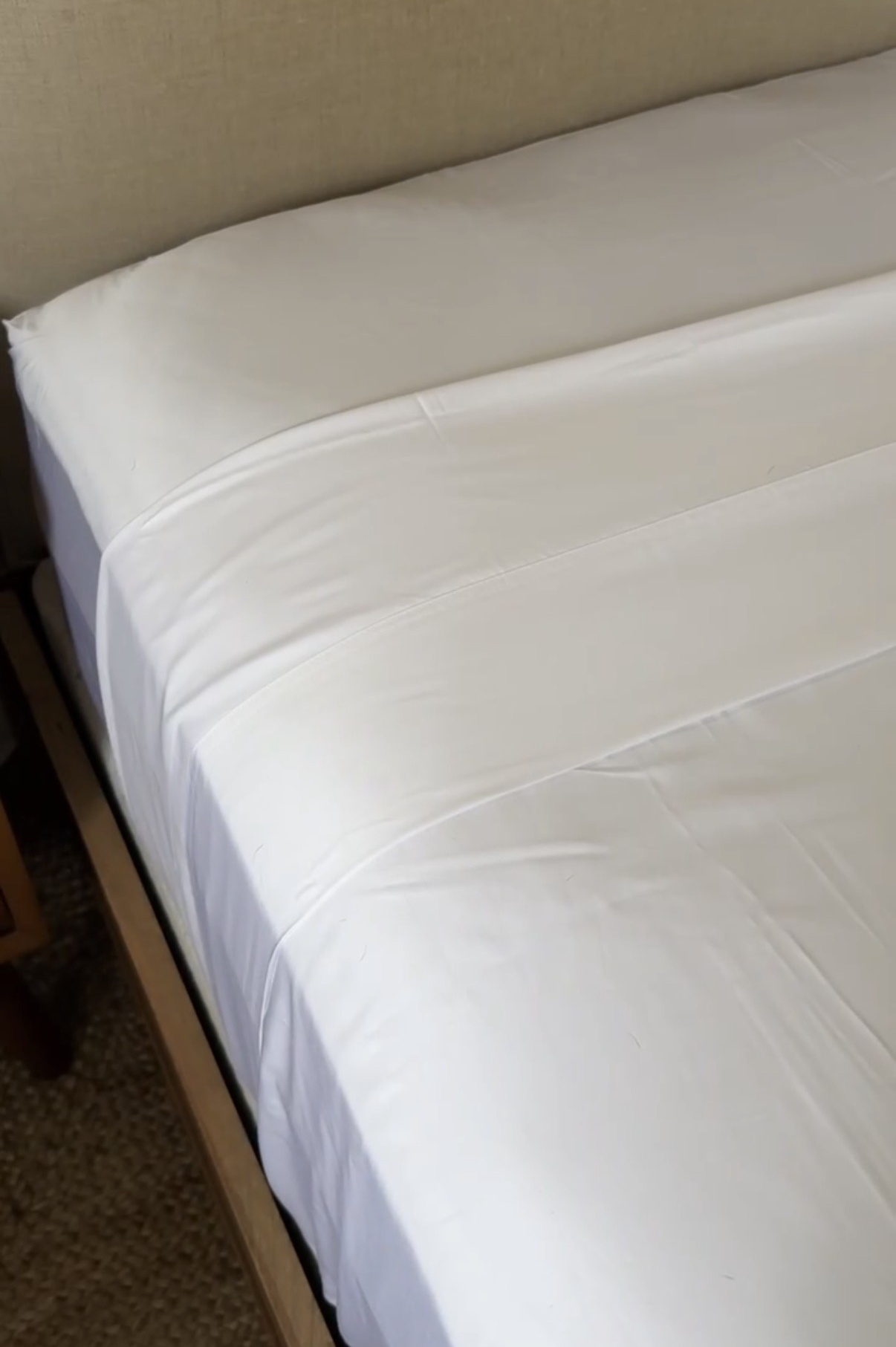 Helix Cool Shift sheets styled on a neutral bed with soft white bedding and layered pillows in a cozy, vintage-inspired bedroom.
