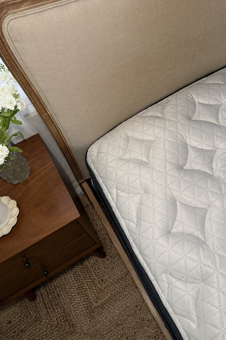 Overhead view of the Helix Twilight Luxe mattress styled with neutral bedding and vintage wood furniture in a cozy bedroom designed for side sleepers and hot sleepers.