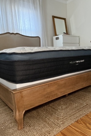 Side profile of the Helix Twilight Luxe mattress showing the thick hybrid mattress construction, plush pillow top, and supportive layered design.